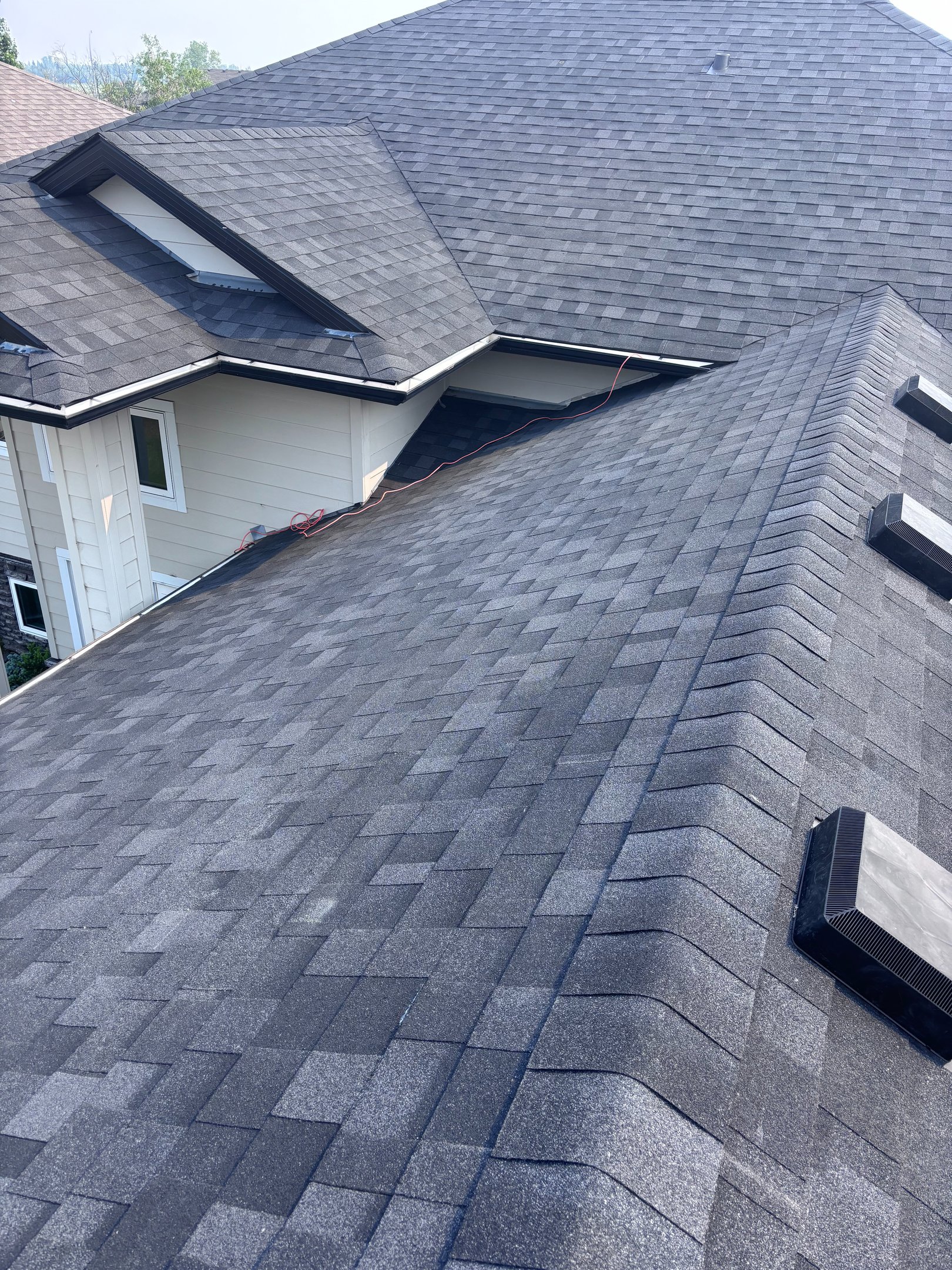 Modern two-story home with a new dark gray shingle roof