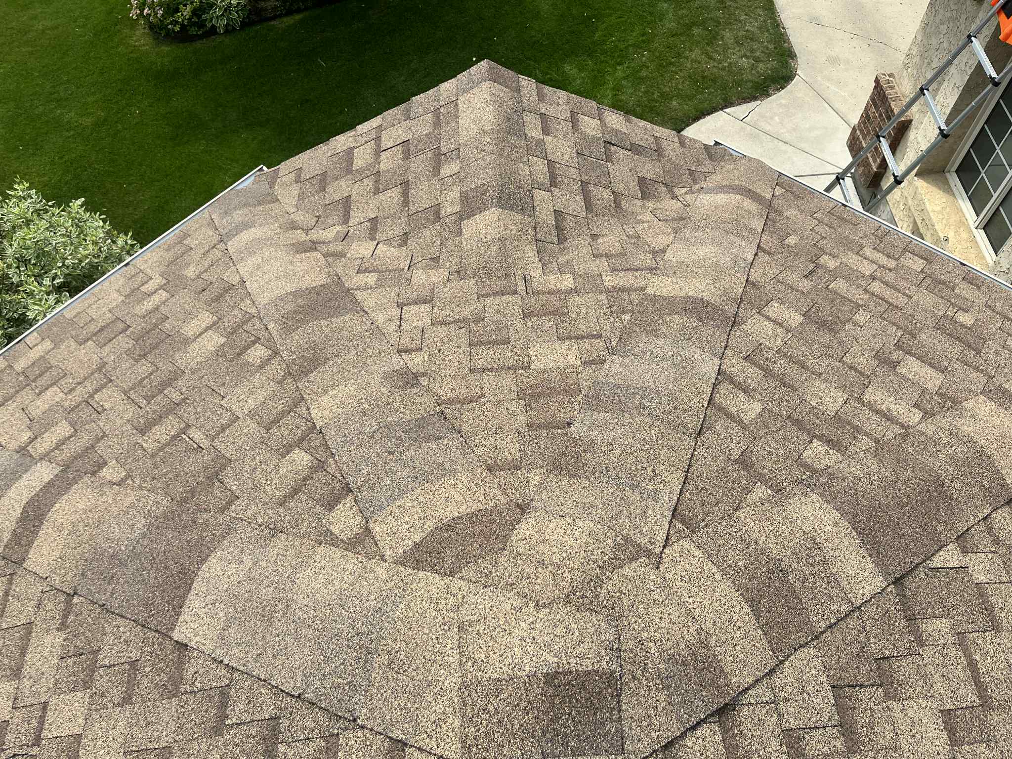 Detail of a brown shingle roof hip and ridge installed by No Stress Roofing