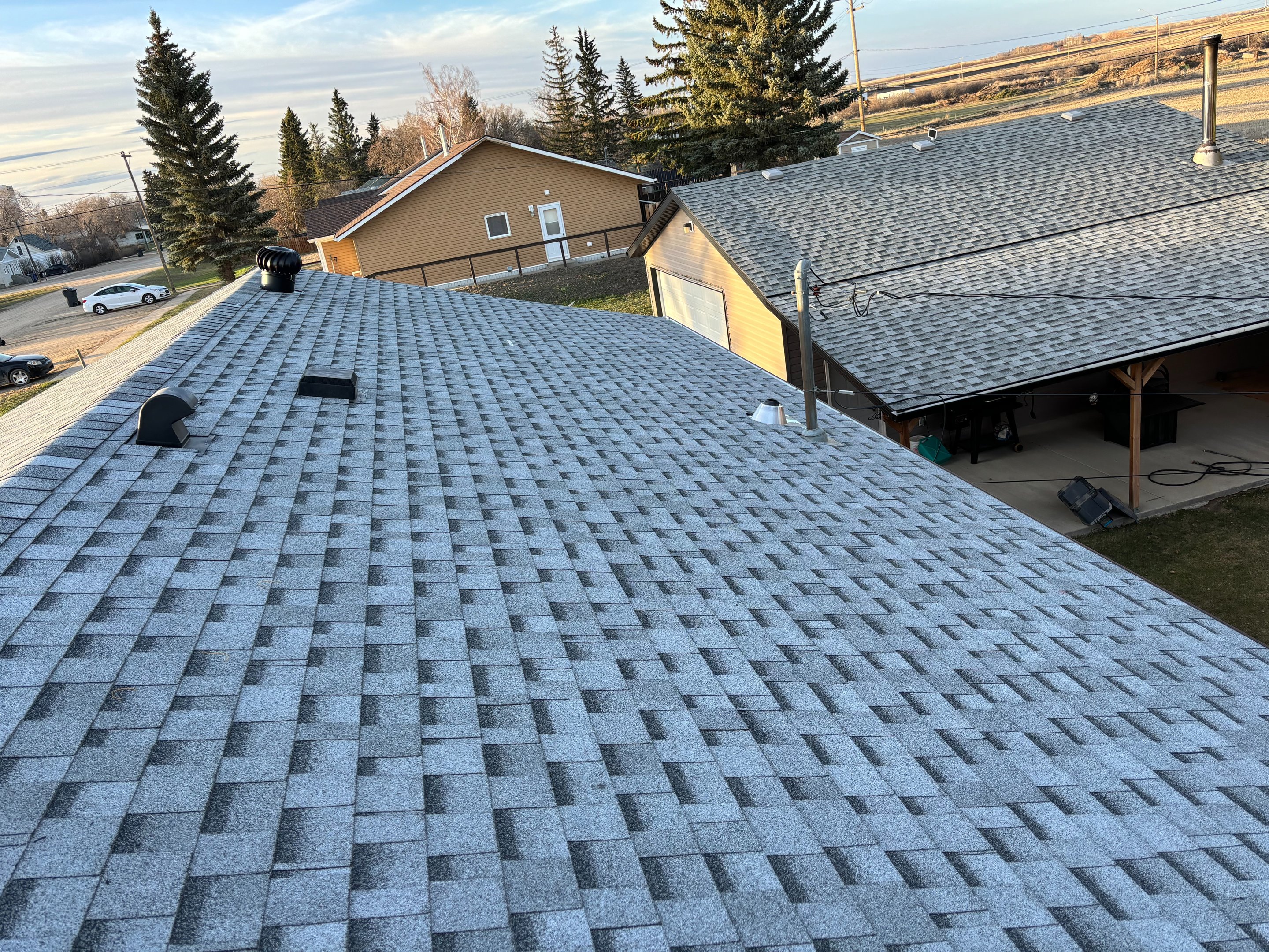 New gray asphalt shingle roof with vents on a Saskatoon home, installed by No Stress Roofing